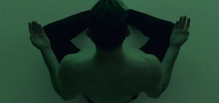 person meditating with green filter overlay